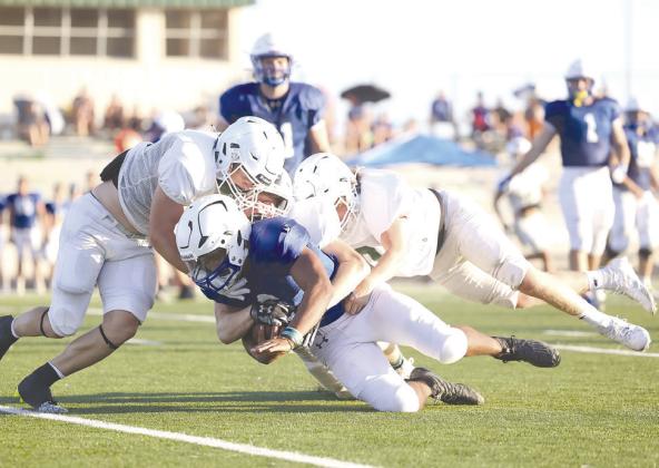 Burnet’s defense swarmed to the ball during Friday’s scrimmage play. Pictured above Dash Denton, Khris Kassner and Holden Valdez quickly stop a Lago back.
