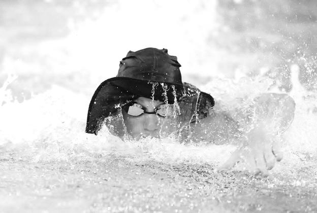 Water drips from the brim of his hat as Stellan Zollitsch finds a way to keep it on his head for his 50-yard swim during the witch hat relay. Wayne Craig/Clear Memories